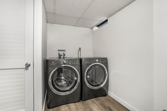 washroom with independent washer and dryer and wood-type flooring