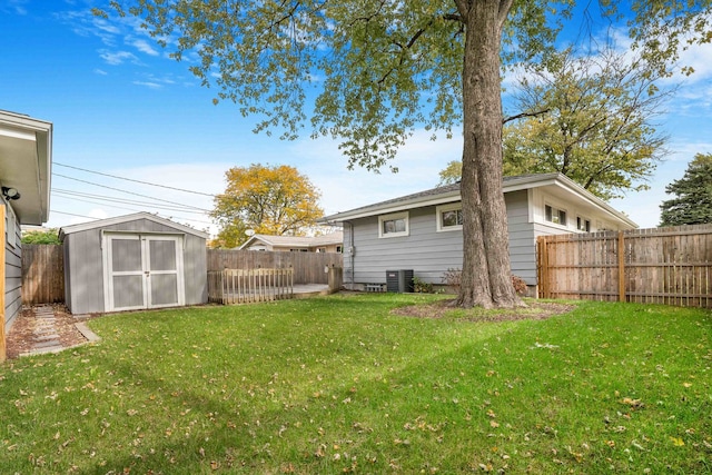 view of yard with a shed and central AC unit