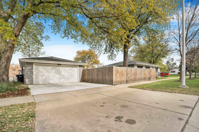 view of side of property featuring a yard and a garage