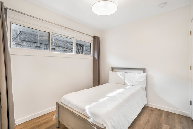 bedroom with hardwood / wood-style floors