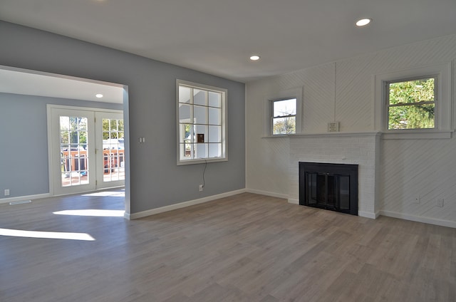 unfurnished living room with a fireplace and wood-type flooring