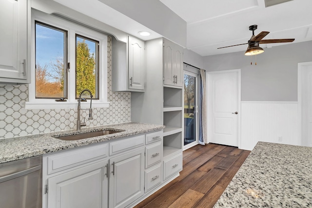 kitchen with white cabinets, light stone countertops, sink, and dark hardwood / wood-style floors