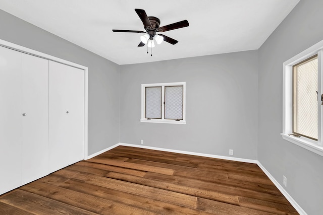 unfurnished bedroom featuring a closet, ceiling fan, and dark hardwood / wood-style floors