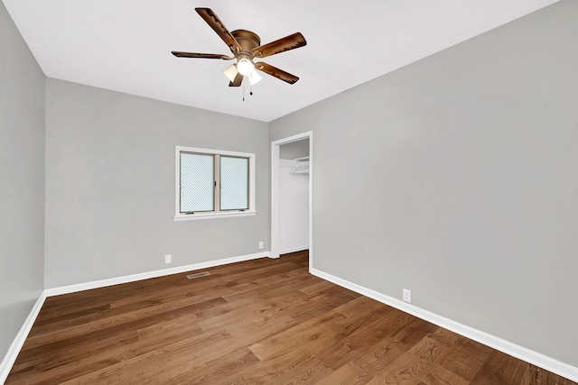 spare room with ceiling fan and wood-type flooring