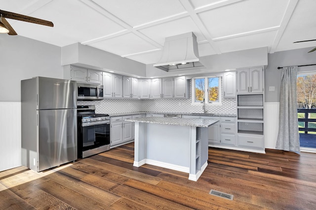 kitchen featuring a center island, appliances with stainless steel finishes, dark hardwood / wood-style floors, and backsplash