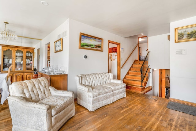 living room with a chandelier and wood-type flooring