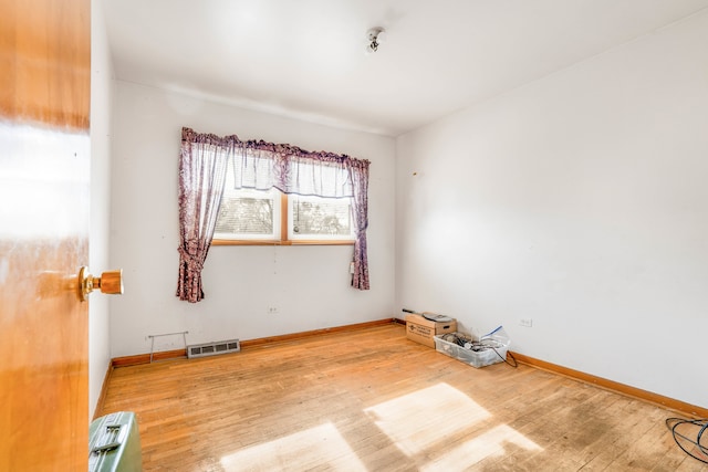 spare room with hardwood / wood-style flooring