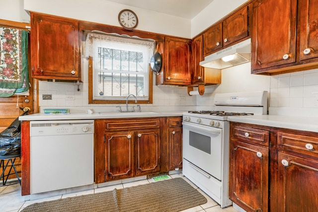 kitchen with sink, light tile patterned flooring, decorative backsplash, and white appliances