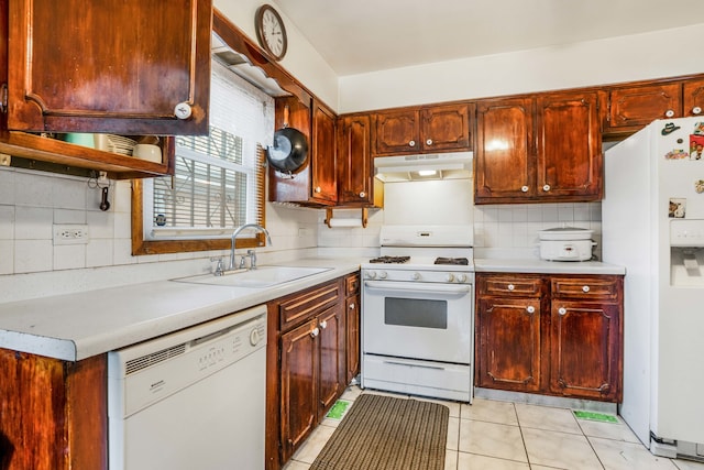 kitchen featuring sink, tasteful backsplash, white appliances, and light tile patterned floors