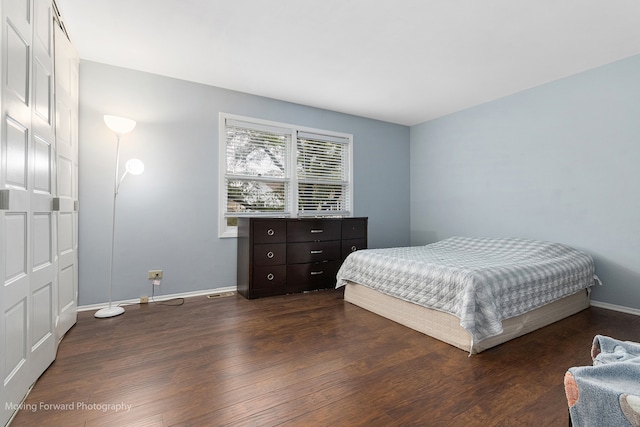 bedroom featuring a closet and dark hardwood / wood-style floors