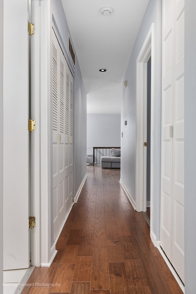 corridor featuring dark hardwood / wood-style floors