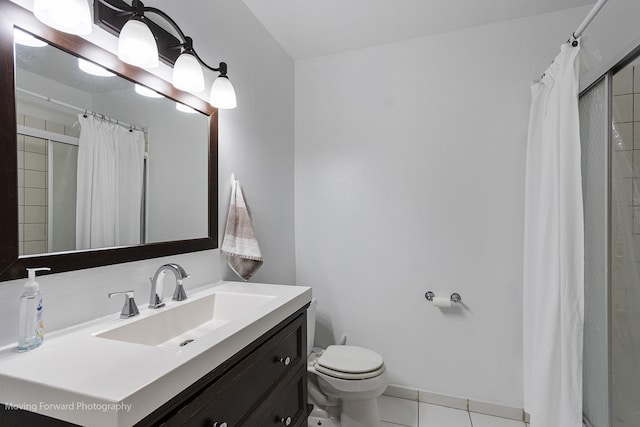 bathroom featuring toilet, vanity, a shower with shower curtain, and tile patterned flooring