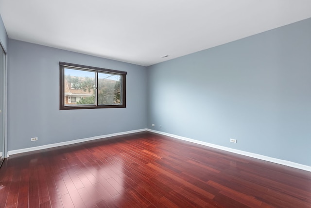 unfurnished room with dark hardwood / wood-style floors