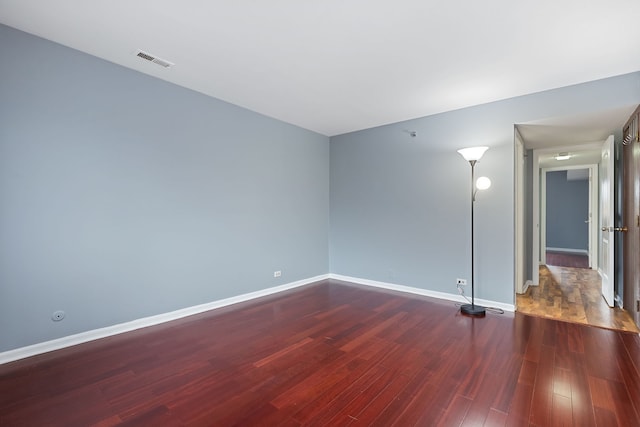 empty room featuring dark wood-type flooring