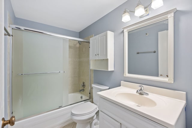 full bathroom with toilet, combined bath / shower with glass door, and vanity