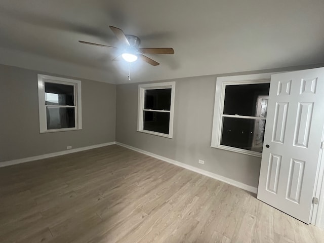 spare room featuring light wood-type flooring and ceiling fan