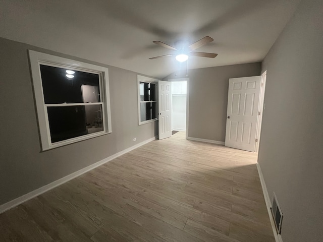 empty room with ceiling fan and wood-type flooring