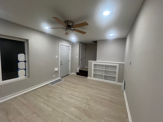 spare room with light wood-type flooring and ceiling fan