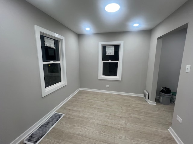 empty room with light hardwood / wood-style floors