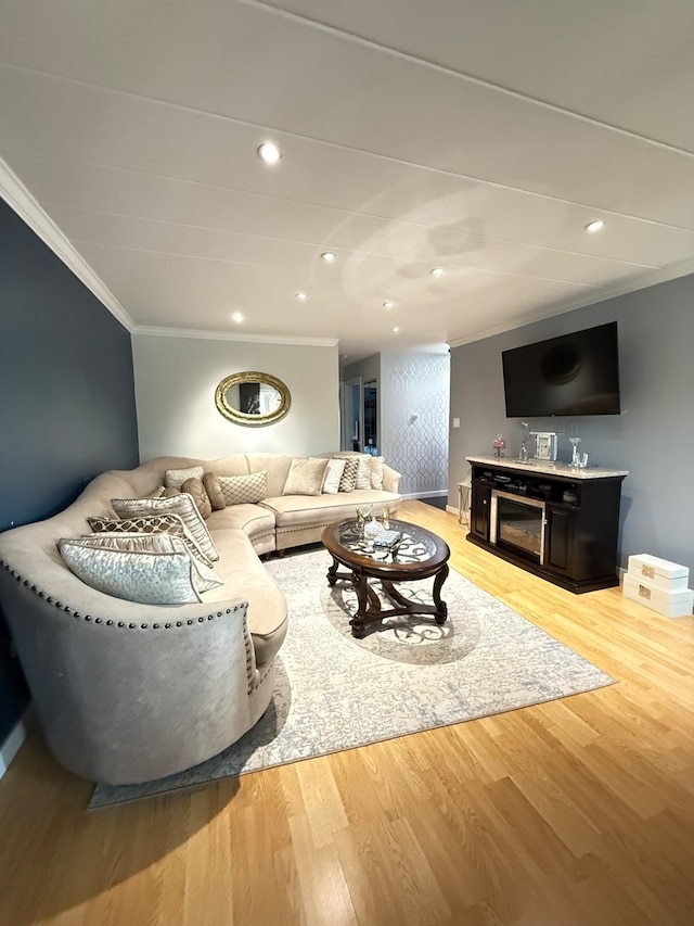 living room featuring ornamental molding and light wood-type flooring