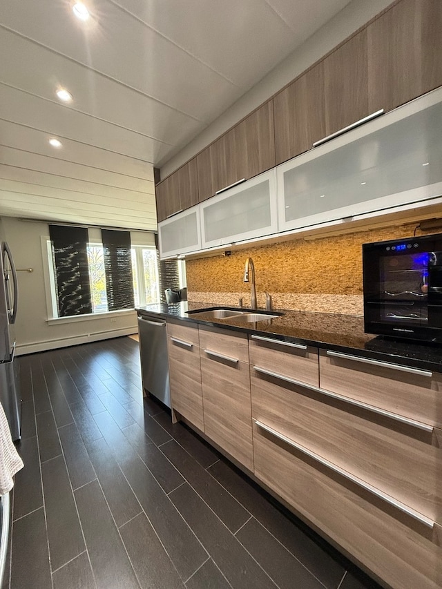 kitchen featuring dishwasher, tasteful backsplash, sink, and dark hardwood / wood-style floors