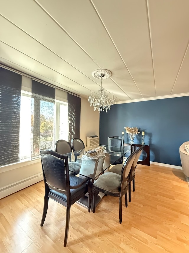 dining area featuring ornamental molding, a chandelier, light hardwood / wood-style flooring, and a baseboard radiator