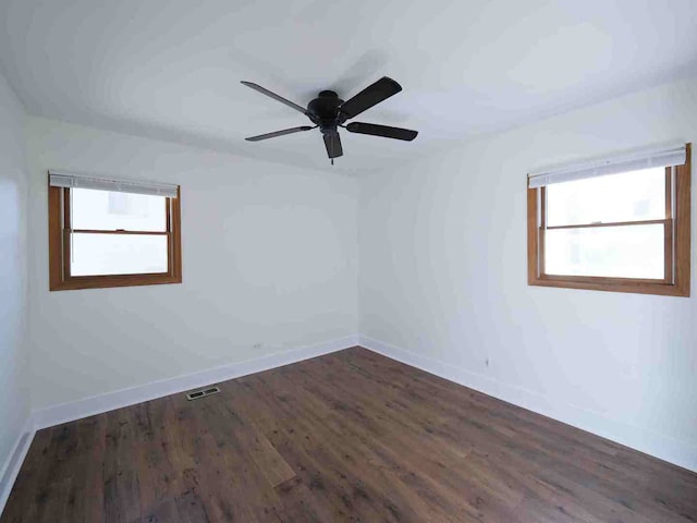 unfurnished room with dark hardwood / wood-style floors and ceiling fan