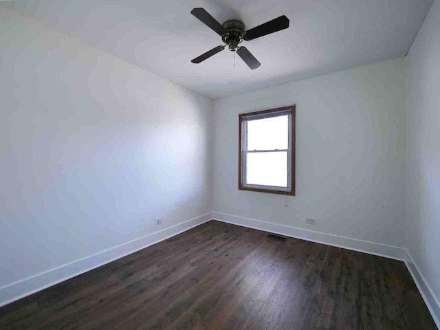 spare room with ceiling fan and dark hardwood / wood-style flooring