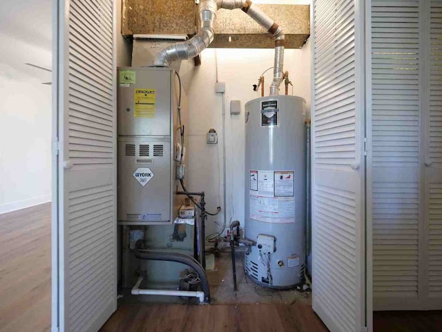 utility room with heating unit and gas water heater