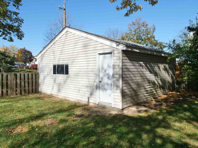 view of side of home with a lawn and an outbuilding