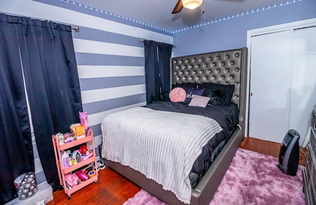 bedroom with wood-type flooring, a closet, and ceiling fan