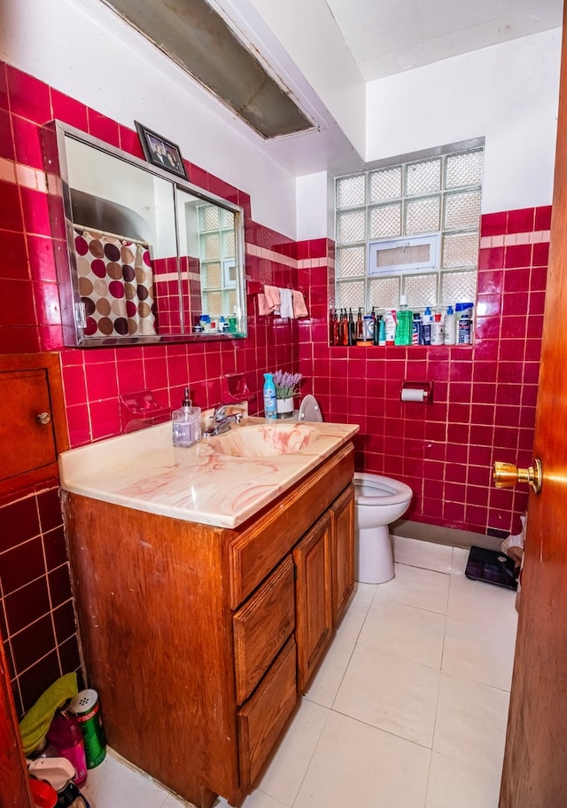 bathroom with vanity, tile patterned floors, and tile walls