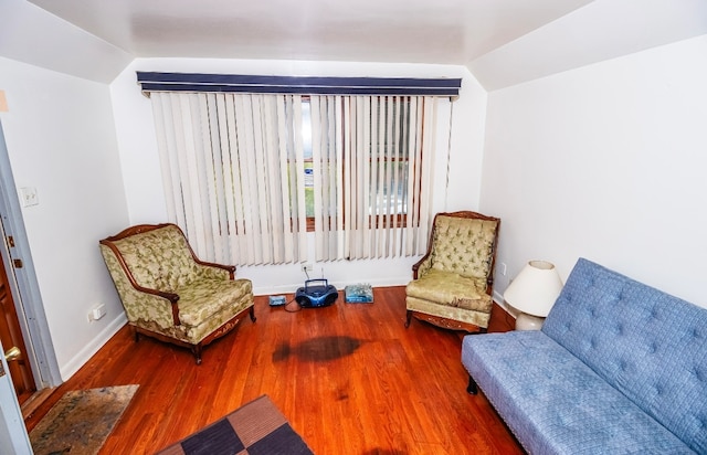 sitting room with hardwood / wood-style flooring and lofted ceiling