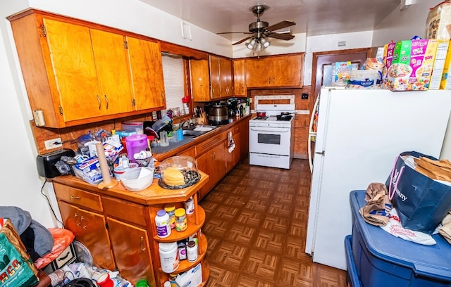 kitchen featuring dark parquet flooring, white appliances, backsplash, sink, and ceiling fan