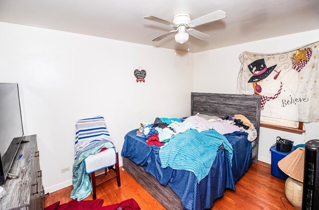 bedroom featuring hardwood / wood-style flooring and ceiling fan