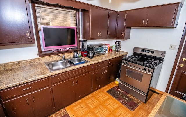 kitchen featuring dark brown cabinetry, sink, light parquet flooring, and stainless steel range with gas stovetop