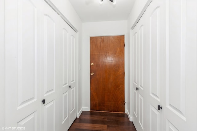 hallway with dark hardwood / wood-style flooring