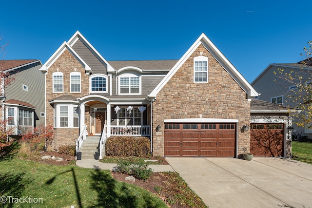 view of front of home with a garage, a porch, and a front lawn