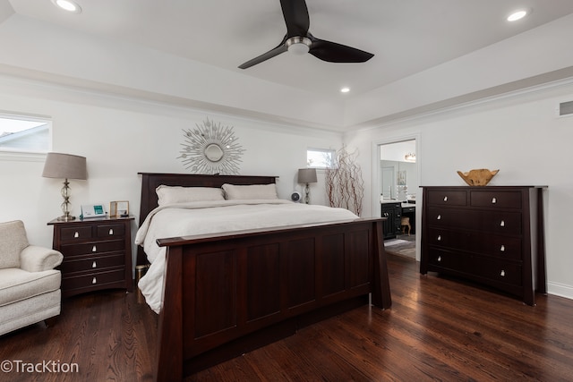 bedroom featuring dark hardwood / wood-style floors, ceiling fan, and connected bathroom