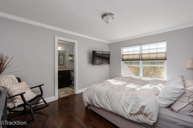 bedroom with dark wood-type flooring, crown molding, and connected bathroom