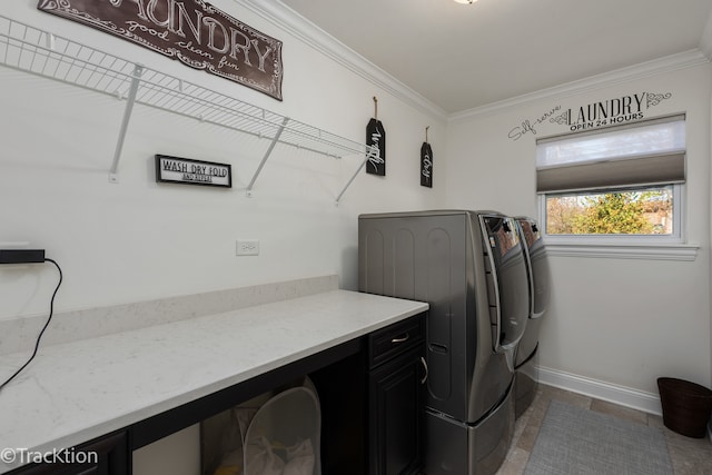 laundry area featuring washer and clothes dryer and ornamental molding