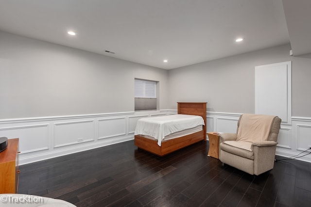 bedroom with dark wood-type flooring