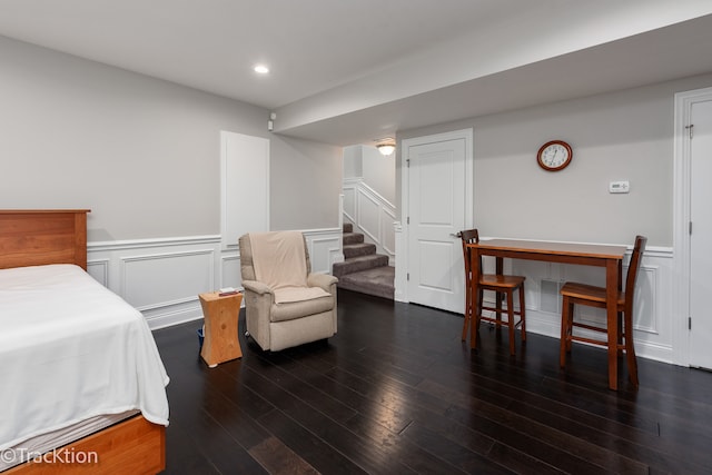 bedroom with dark hardwood / wood-style flooring