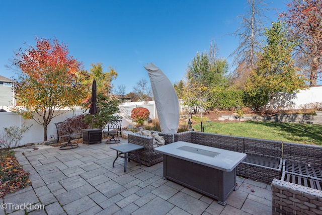 view of patio featuring an outdoor living space with a fire pit