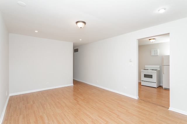 spare room featuring light hardwood / wood-style floors