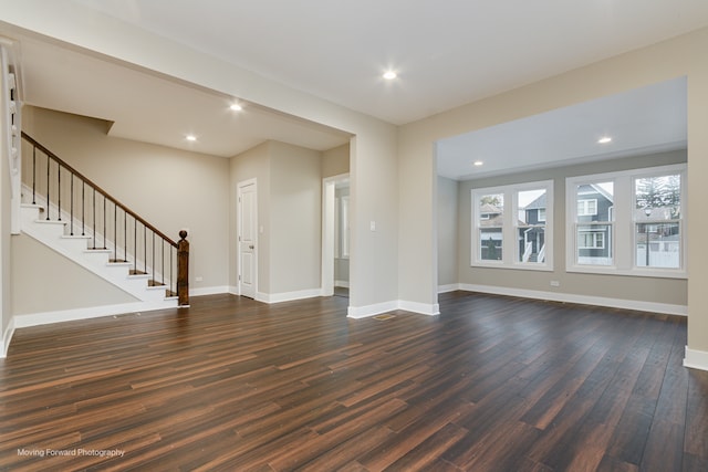 unfurnished living room with dark hardwood / wood-style floors