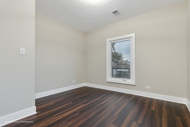 spare room featuring dark hardwood / wood-style floors