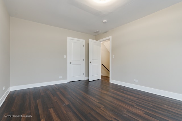 unfurnished room with dark hardwood / wood-style floors