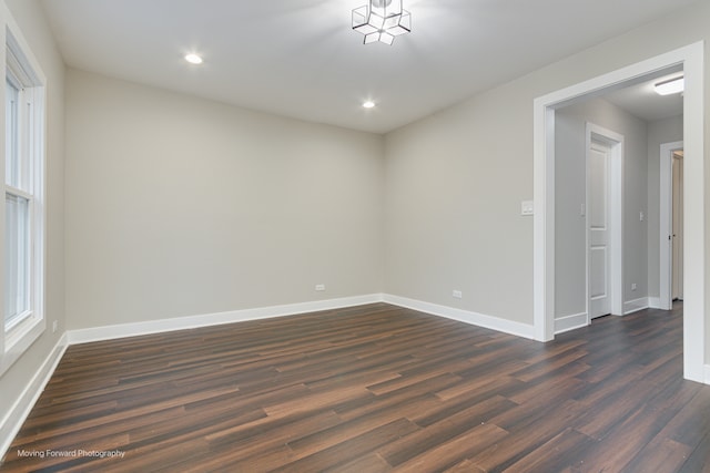 spare room with dark hardwood / wood-style flooring