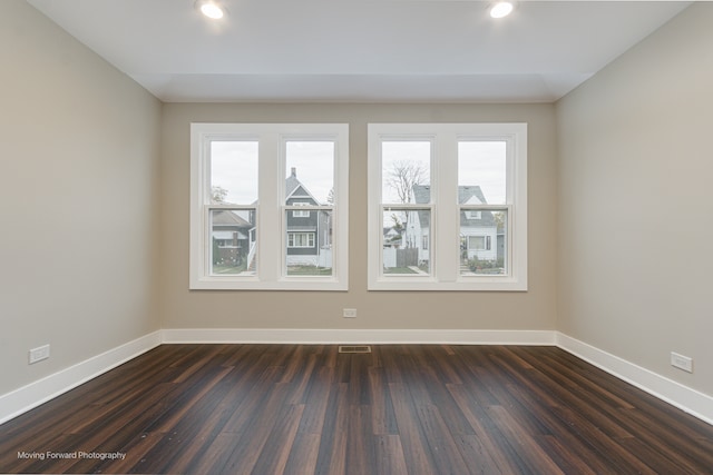 empty room featuring dark wood-type flooring